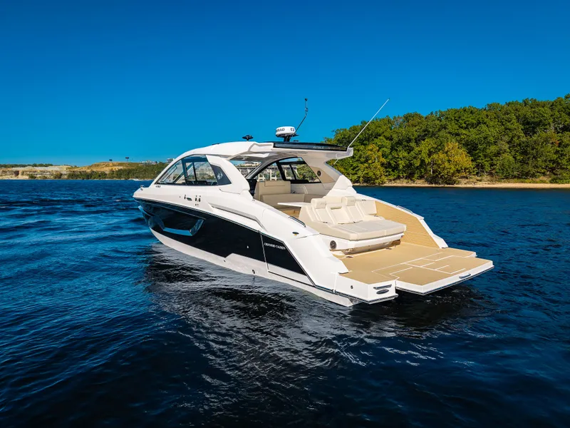 Slide: The Image of The 2027 Cruisers Yachts 42 GLS is a sleek boat with a spacious deck and luxurious seating. - 4