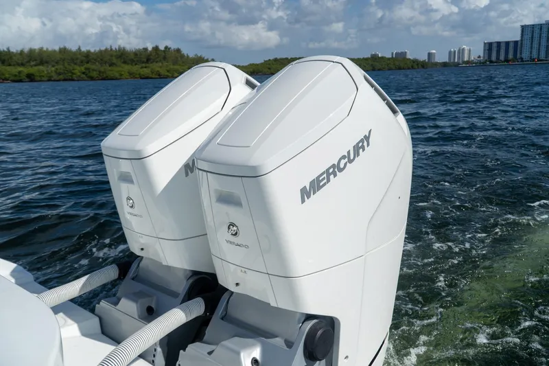 Slide: The Image of Twin Mercury outboard engines on a 2022 Yellowfin 39 Offshore boat in open water. - 12