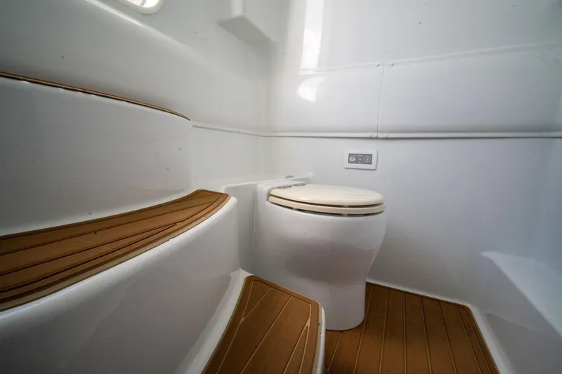 Slide: The Image of 2022 Yellowfin 39 Offshore boat bathroom with wooden flooring and modern toilet. - 30