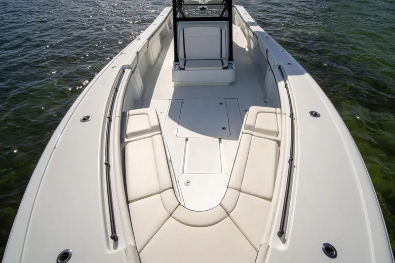 Slide: The Image of 2022 Yellowfin 39 Offshore boat with spacious deck and seating, cruising on clear water. - 20