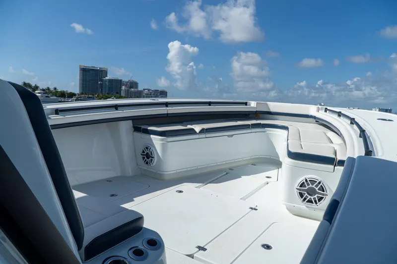 Slide: The Image of 2022 Yellowfin 39 Offshore boat deck with seating, under a clear blue sky. - 14