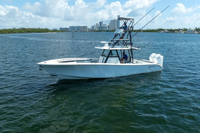 Slide: The Image of 2022 Yellowfin 39 Offshore boat on water with city skyline in background. - 34