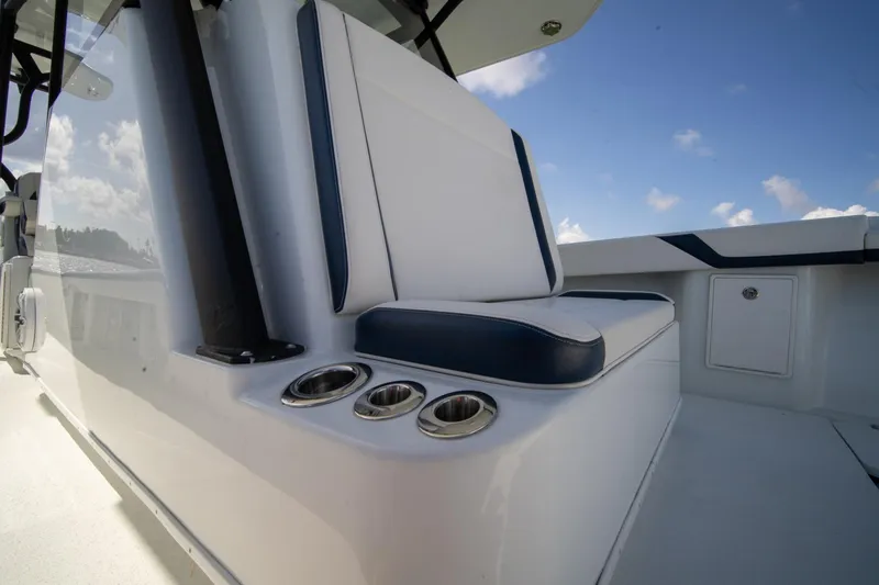 Slide: The Image of 2022 Yellowfin 39 Offshore boat interior with cushioned seating and cup holders. - 23