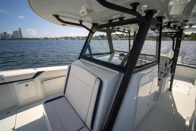 Slide: The Image of 2022 Yellowfin 39 Offshore boat interior with seating, overlooking a scenic waterfront. - 21