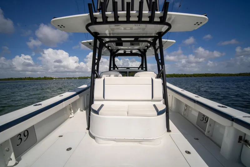 Slide: The Image of 2022 Yellowfin 39 Offshore boat interior with seating, on a sunny day at sea. - 7