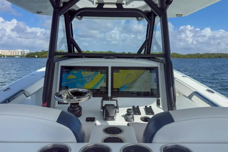 Slide: The Image of 2022 Yellowfin 39 Offshore boat cockpit with dual navigation screens on a sunny day. - 29