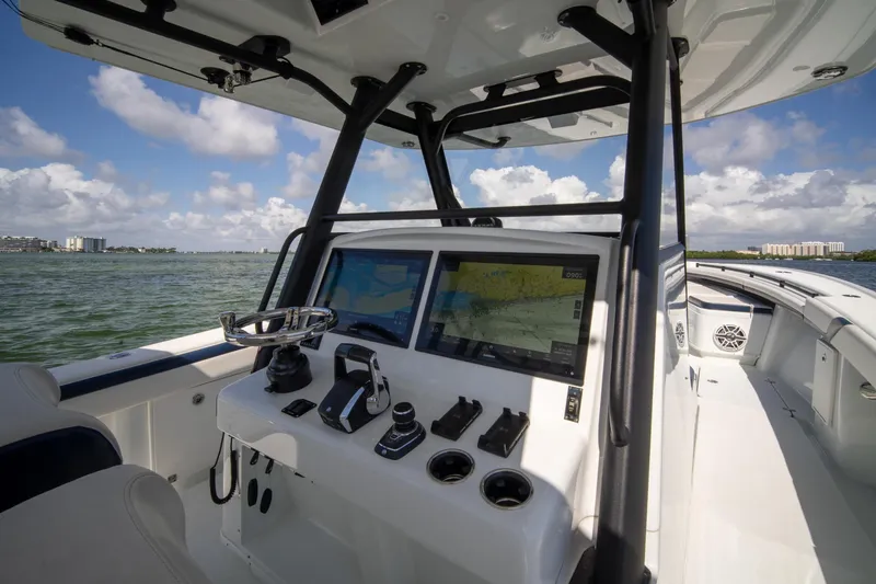Slide: The Image of 2022 Yellowfin 39 Offshore boat cockpit with navigation screens and steering wheel. - 6