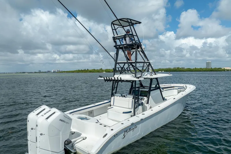 Slide: The Image of 2022 Yellowfin 39 Offshore boat with tower, cruising on open water under cloudy skies. - 3
