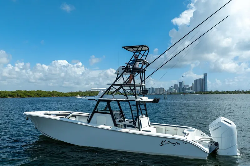 Slide: The Image of 2022 Yellowfin 39 Offshore boat on water with city skyline in background. - 32