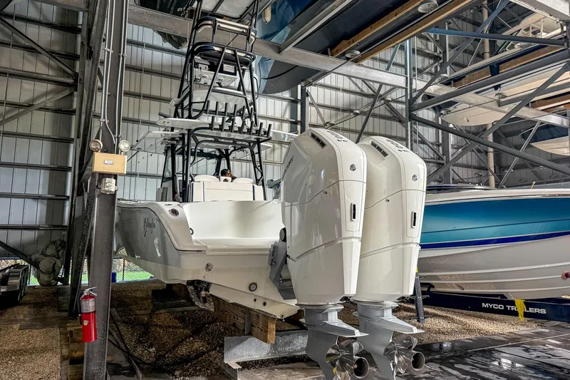 Slide: The Image of 2022 Yellowfin 39 Offshore boat with dual outboard engines in a storage facility. - 36