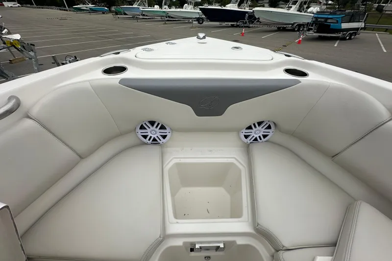 Slide: The Image of 2026 Sailfish 232 CC boat interior with cushioned seating and cup holders. - 24