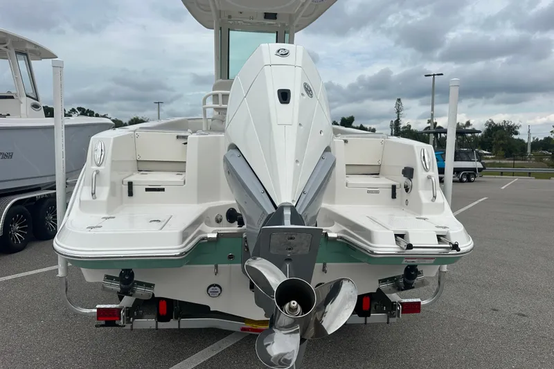 Slide: The Image of 2026 Sailfish 232 CC boat with powerful outboard motor in a parking lot. - 15