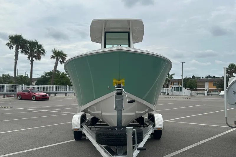 Slide: The Image of 2026 Sailfish 232 CC boat on trailer in parking lot, overcast sky. - 11