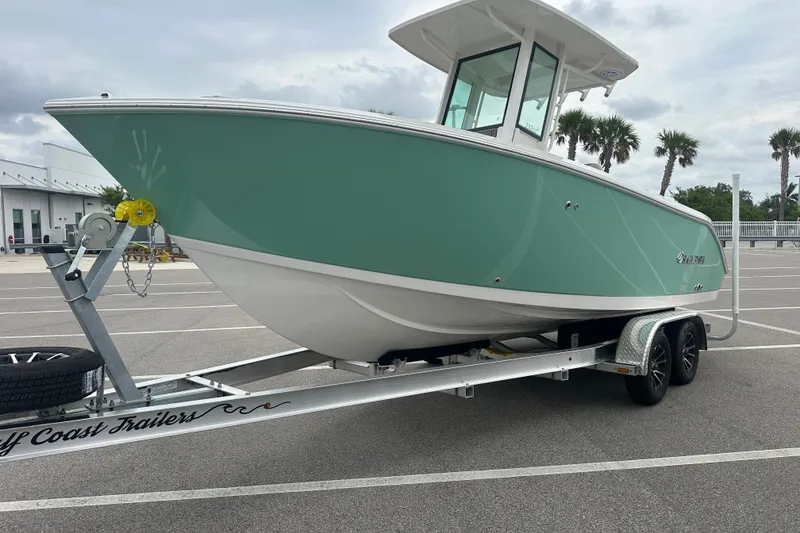 Slide: The Image of 2026 Sailfish 232 CC boat on trailer in parking lot, overcast sky. - 10