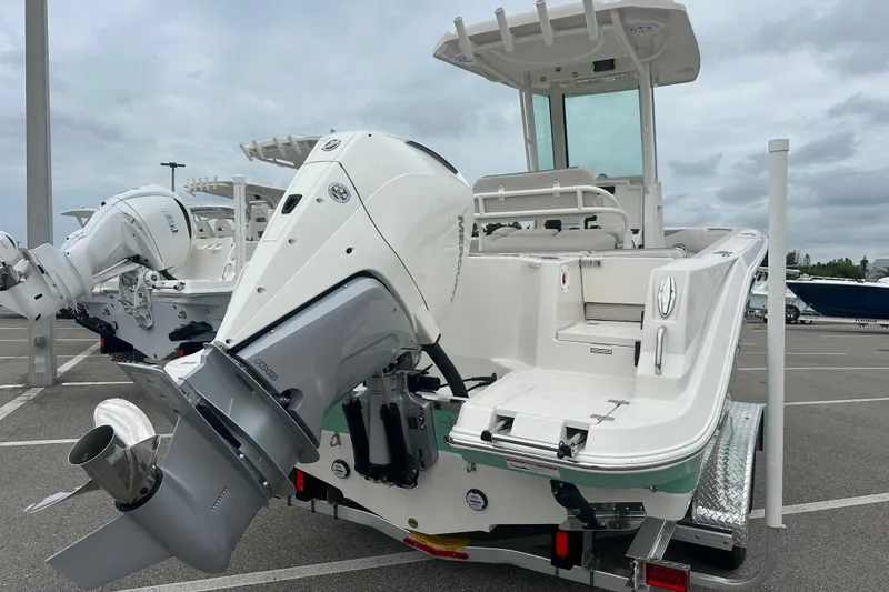 Slide: The Image of 2026 Sailfish 232 CC boat with powerful outboard motor in a parking lot. - 16