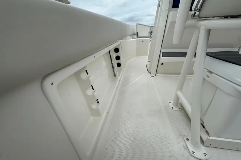 Slide: The Image of 2026 Sailfish 232 CC boat interior, featuring sleek white design and seating area. - 17