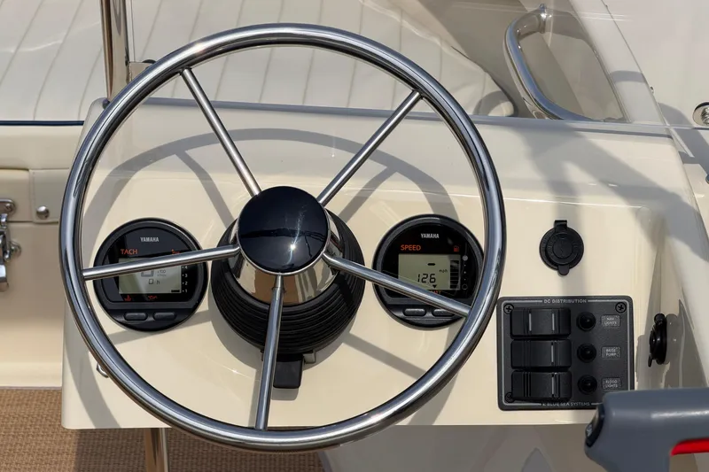 Slide: The Image of Steering wheel and dashboard of 2027 Rossiter 14 boat with Yamaha gauges. - 22