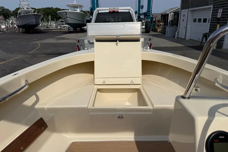Slide: The Image of Interior view of a 2027 Rossiter 14 boat at a marina, showcasing storage compartment. - 27