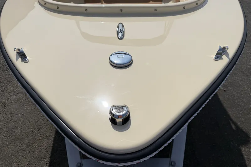 Slide: The Image of Bow of a 2027 Rossiter 14 boat with chrome fittings and beige finish. - 30