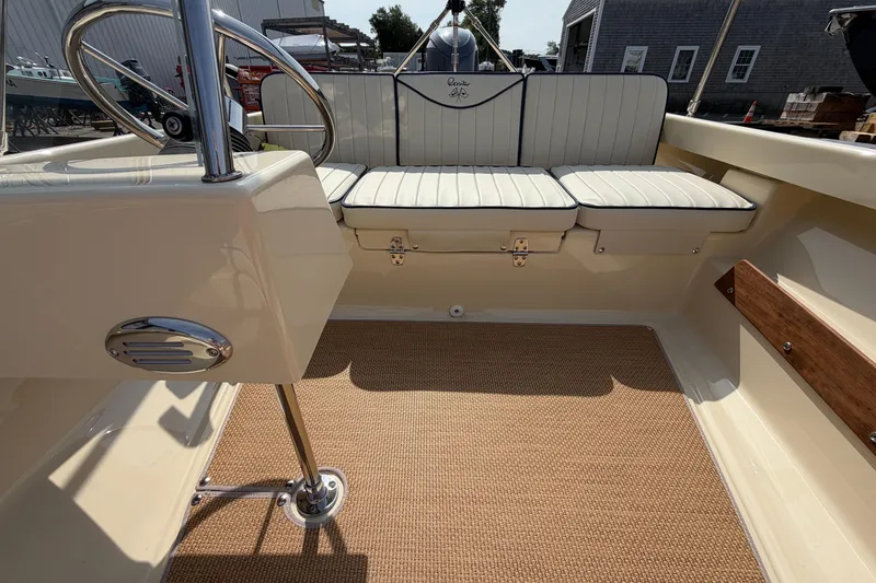Slide: The Image of Interior of a 2027 Rossiter 14 boat with cushioned seating and steering wheel. - 28