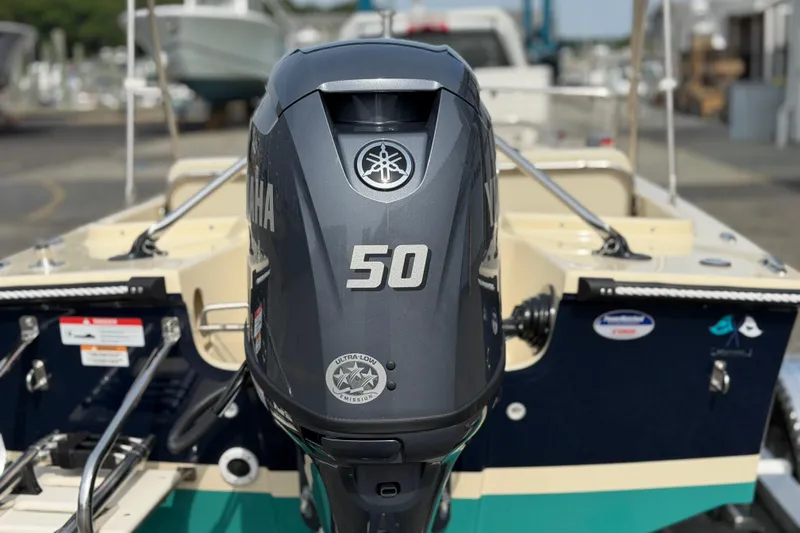 Slide: The Image of Rossiter 14 boat with Yamaha 50 engine, 2027 model, in a marina setting. - 10