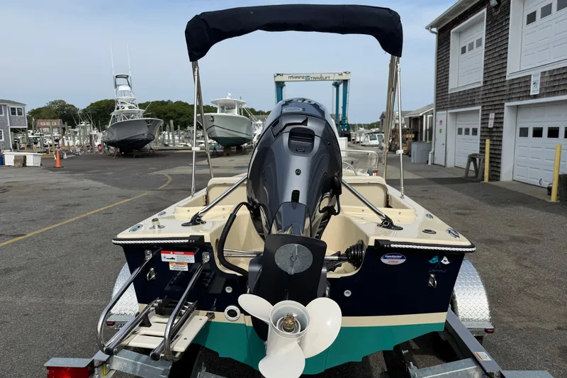 Slide: The Image of 2027 Rossiter 14 boat with outboard motor on trailer at marina. - 4