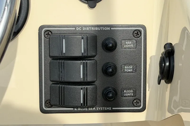 Slide: The Image of Control panel of a 2027 Rossiter 14 boat with switches for nav lights, bilge pump, and flood lights. - 25