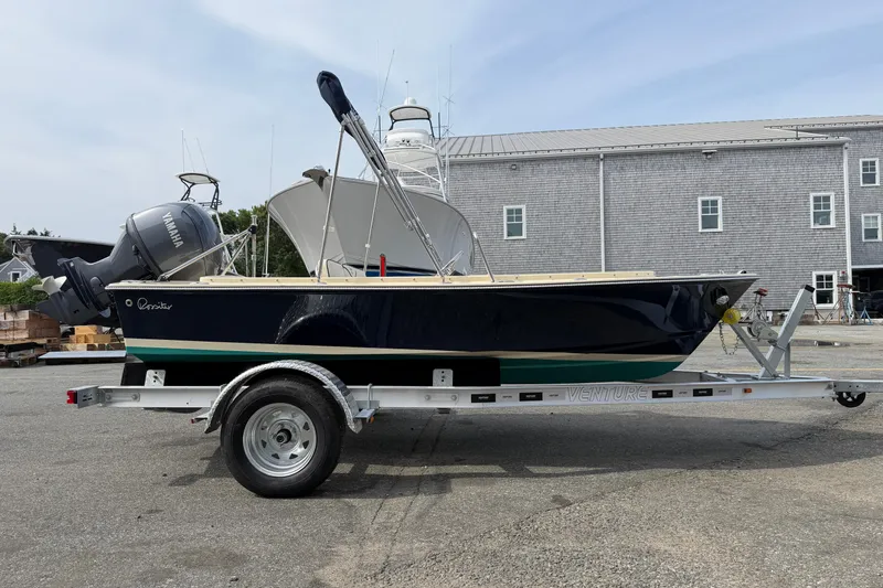 Slide: The Image of 2027 Rossiter 14 boat on trailer, featuring Yamaha outboard motor, parked outdoors. - 1