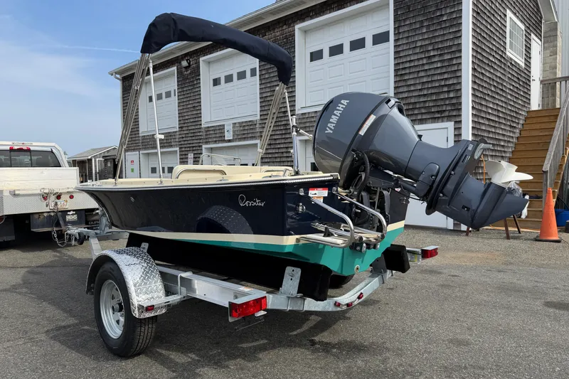 Slide: The Image of 2027 Rossiter 14 boat on trailer with Yamaha outboard motor, parked near a building. - 5