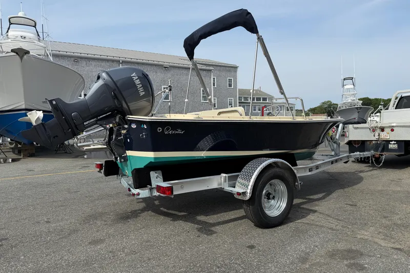 Slide: The Image of 2027 Rossiter 14 boat on trailer with Yamaha outboard motor, parked in marina. - 2