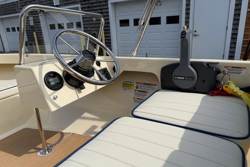 Slide: The Image of 2027 Rossiter 14 boat interior with steering wheel and Yamaha controls. - 21