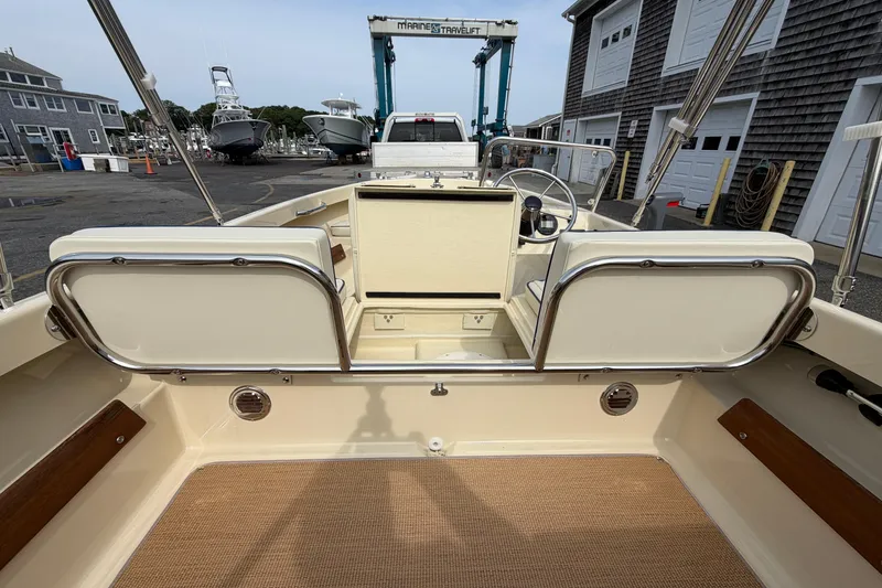 Slide: The Image of Rossiter 14 boat interior, 2027 model, docked at a marina with nautical equipment. - 15