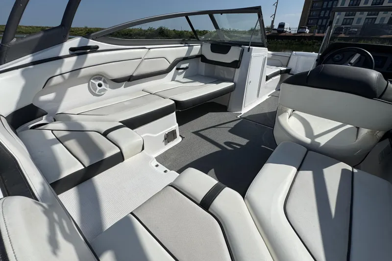Slide: The Image of 2018 Yamaha Boats AR210 interior with sleek white seating and modern design. - 21