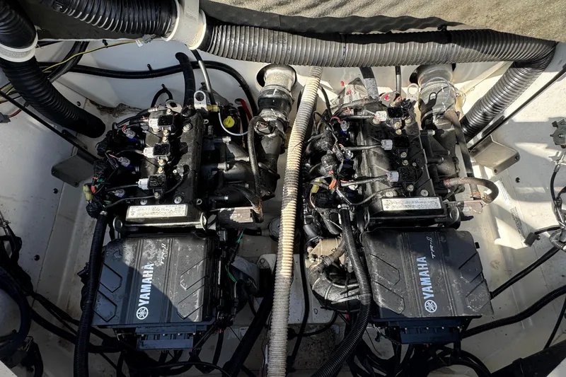 Slide: The Image of Twin engines of a 2018 Yamaha Boats AR210, showcasing intricate wiring and components. - 22