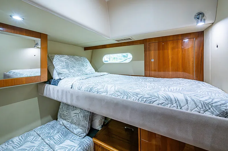 Slide: The Image of Luxurious cabin interior of 2009 Riviera 58 Flybridge yacht with cozy bedding. - 38