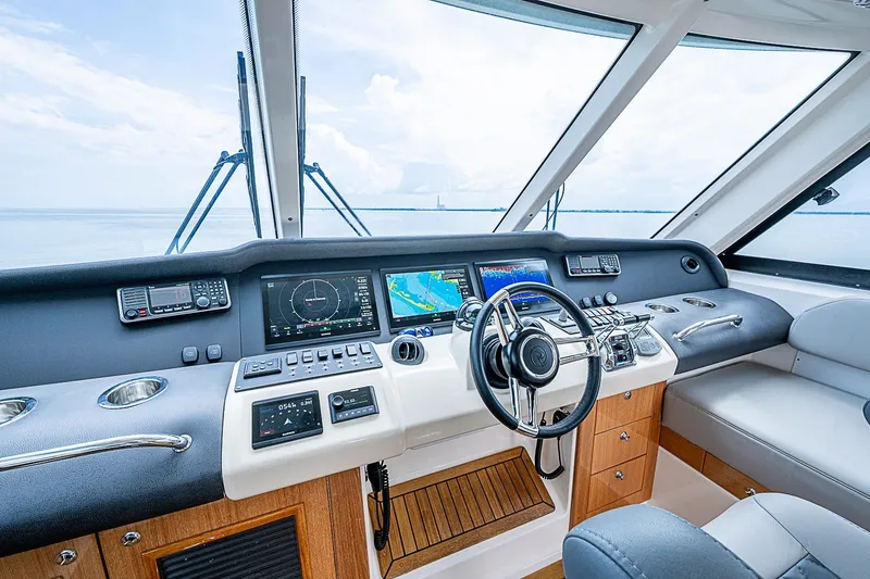 Slide: The Image of Luxurious 2009 Riviera 58 Flybridge helm with advanced navigation systems and panoramic views. - 62