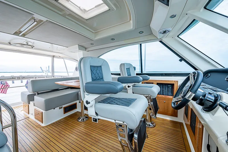 Slide: The Image of Luxurious 2009 Riviera 58 Flybridge interior with plush seating and modern helm controls. - 60