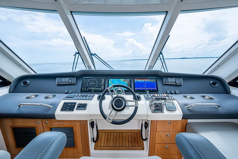 Slide: The Image of Luxurious 2009 Riviera 58 Flybridge yacht helm with advanced navigation systems and panoramic views. - 66