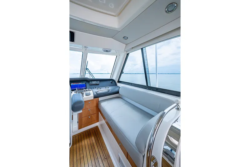 Slide: The Image of Luxurious interior of 2009 Riviera 58 Flybridge yacht with sleek seating and navigation controls. - 67