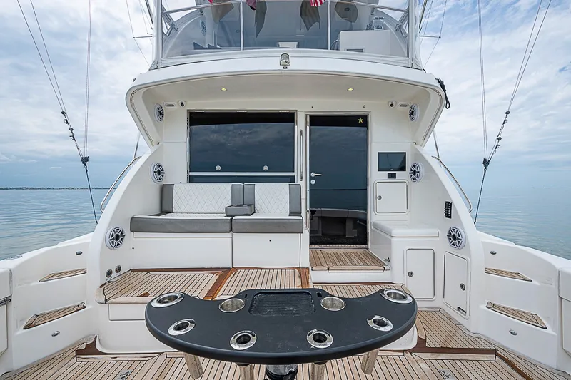 Slide: The Image of Luxurious 2009 Riviera 58 Flybridge yacht with spacious deck and seating area. - 81