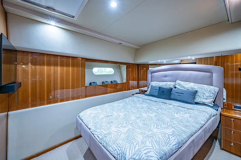 Slide: The Image of Luxurious bedroom interior of 2009 Riviera 58 Flybridge yacht with elegant wood paneling. - 29