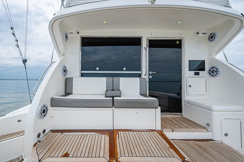 Slide: The Image of 2009 Riviera 58 Flybridge yacht with elegant seating and teak flooring. - 78
