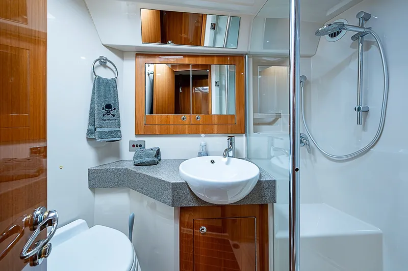 Slide: The Image of Luxurious bathroom in 2009 Riviera 58 Flybridge yacht with modern fixtures and elegant design. - 50