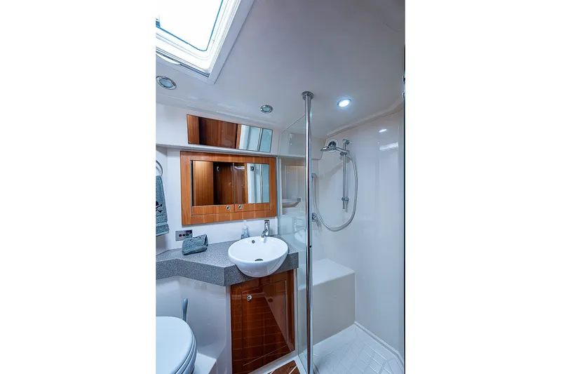 Slide: The Image of Luxurious bathroom in 2009 Riviera 58 Flybridge yacht with modern fixtures and wood accents. - 51