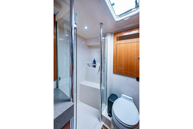 Slide: The Image of Luxurious bathroom in 2009 Riviera 58 Flybridge yacht with modern fixtures and wooden accents. - 33