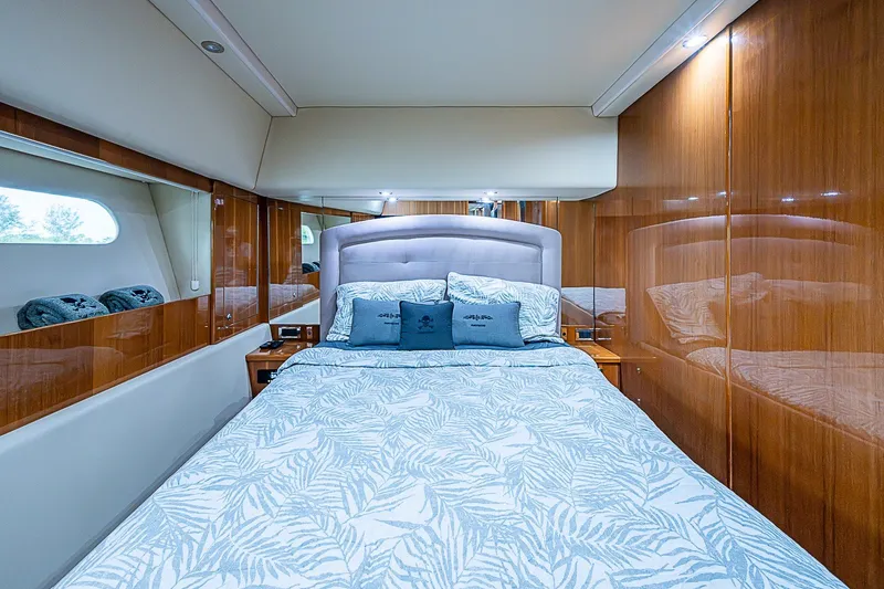 Slide: The Image of Luxurious bedroom interior of 2009 Riviera 58 Flybridge yacht with elegant wood paneling. - 31