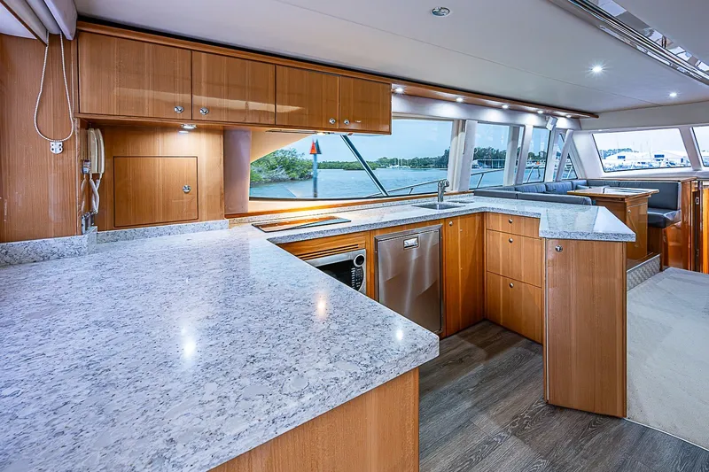 Slide: The Image of Luxurious 2009 Riviera 58 Flybridge yacht interior with modern kitchen and scenic window views. - 15