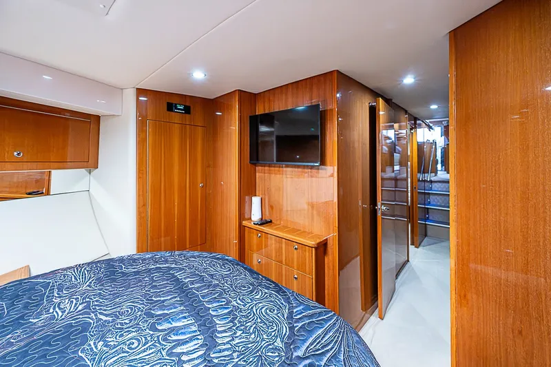 Slide: The Image of Luxurious 2009 Riviera 58 Flybridge yacht interior with wood paneling and modern amenities. - 47