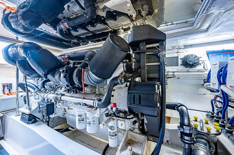 Slide: The Image of Engine room of 2009 Riviera 58 Flybridge yacht, showcasing detailed mechanical components. - 44