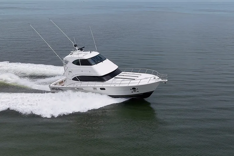 Slide: The Image of 2009 Riviera 58 Flybridge yacht cruising on calm waters. - 104